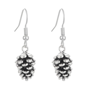Detailed macro view of silver pine cone earrings with natural textured metal scales