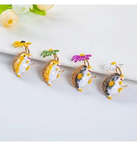Macro shot of four colorful enamel hedgehog brooches in various floral colors and designs