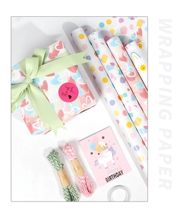 Detail of colorful gift wrapping paper rolls with ribbons, cards and twine for birthdays