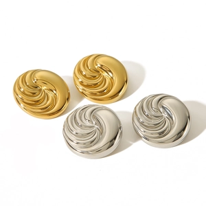 Fashionable 18k gold and silver circular earrings with spiral texture on white background
