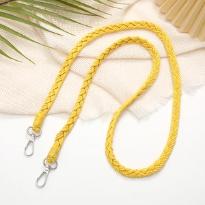 Close-up of yellow hand-woven braided lanyard strap with silver metal lobster clasps