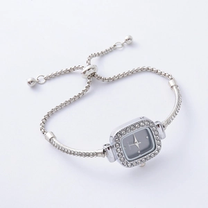 Macro detail of silver square watch dial with rhinestones and adjustable link chain