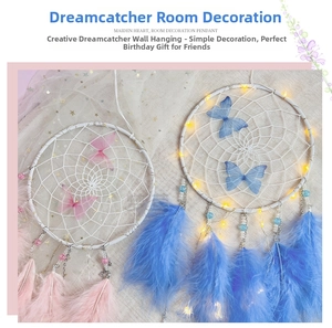 Detail of handmade butterfly dreamcatcher with soft feathers and warm LED light string