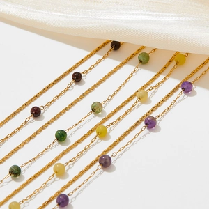 Elegant gold stainless steel necklaces with colorful natural stone beads on silk fabric