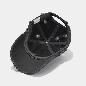 Close-up of 100% cotton wash label and distressed interior of black baseball cap