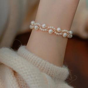 Double-layer baroque pearl bracelet with 14K gold plating worn on woman wrist
