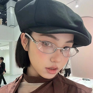 Silver oval metal frame sunglasses with sparkling diamond accents on temples for women