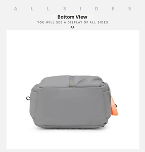 Detail view of the durable grey nylon backpack base with precision stitching and orange tag