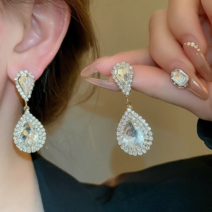 Detailed view of luxury silver water-drop earrings set with sparkling rhinestones