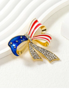 Macro shot of American flag bow brooch with crystals and red blue enamel on gold metal