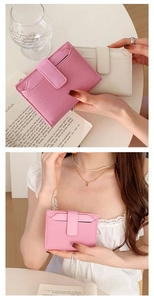 Close-up of pink and white PU leather bifold wallets with zipper and clasp details