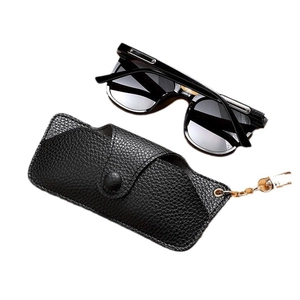 Black leather sunglasses case with gold chain and matching classic sunglasses set