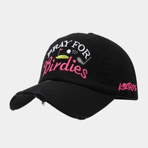 Detail of embroidered Pray For Birdies logo and distressed edge on black cotton baseball cap