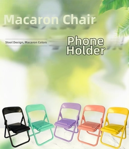 Row of colorful mini folding chair phone holders in vibrant macaron shades on marble