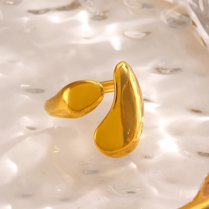 Gold fluid liquid metal ring with mirror finish on water ripple background