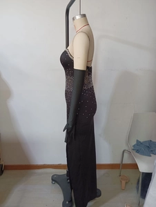Detail of black strapless evening dress with silver rhinestones and long gloves