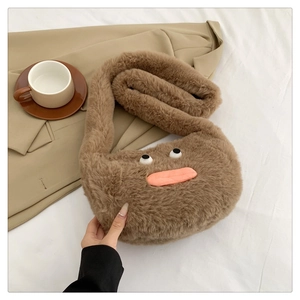 Detail of cute brown plush crossbody bag with funny cartoon face on beige blazer