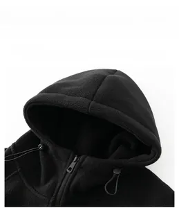Close-up of black fleece jacket showing hood drawstring and smooth zipper detail