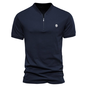 Detail of navy blue polo shirt with zip V-neck and white embroidered lion head logo