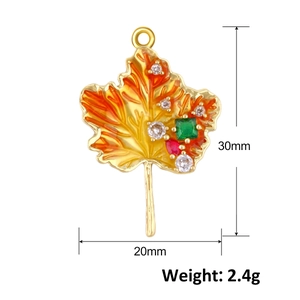 Detail of 30mm maple leaf pendant with orange gradient enamel and colorful rhinestones
