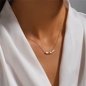 Close-up of minimalist gold S925 silver necklace with marquise-cut cluster diamonds