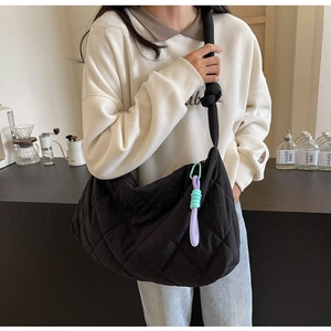 Quilted black puffer tote bag for women showing large capacity and crossbody style