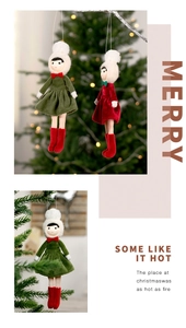Close-up of knit Christmas doll hanging ornaments in festive red, green, and white colors