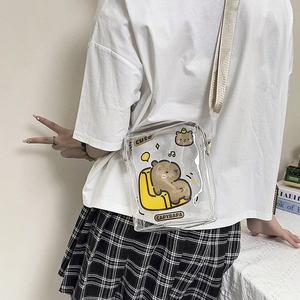 Back view of a transparent capybara crossbody bag shown on a model with a plaid skirt