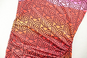 Close-up of ruched side detail and gradient geometric leaf print on bodycon dress