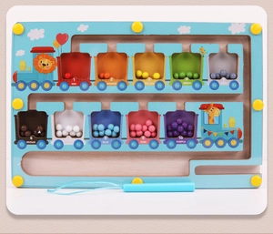 Detail of wooden magnetic train maze showing colorful numbered cars and magnetic pen
