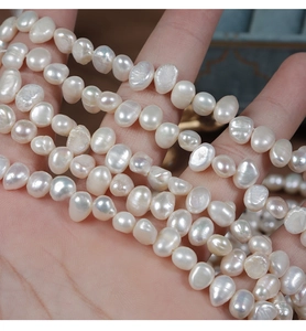 Macro detail of natural white baroque pearls for handmade jewelry DIY crafting