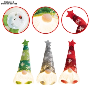 Close-up of three glowing Christmas gnomes with LED lights and battery compartment detail