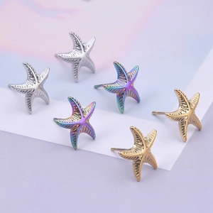 Detail view of starfish earrings in silver, gold, and iridescent stainless steel