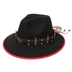 Detail of black cowboy hat with red trim, leather band, and eagle emblem ornament