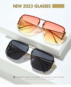 Close-up of square sunset gradient lenses and premium gold metal frames on white steps