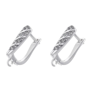 Macro shot of silver U-shaped earring hoops featuring cubic zirconia and hanging loops