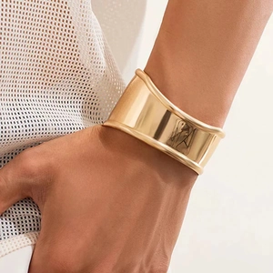 Minimalist wide open cuff bracelet in gold-plated stainless steel with mirror finish