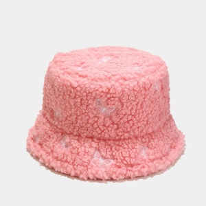 Close-up of pink teddy fleece bucket hat with detailed white butterfly embroidery texture