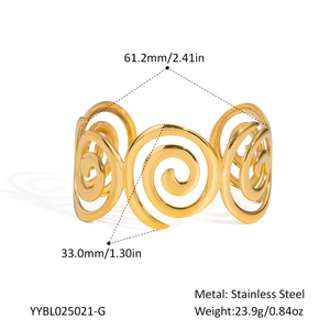 Macro detail of golden spiral cutout bangle showing dimensions and stainless steel texture