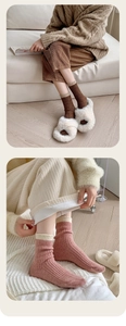 Detail of color-block ribbed wool socks paired with plush slippers in cozy home setting