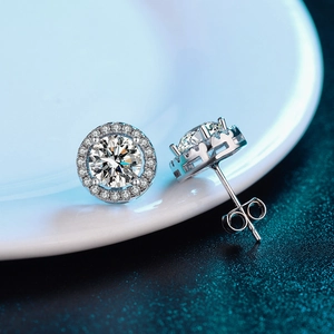 Macro shot of 925 sterling silver D color moissanite halo stud earrings with butterfly back