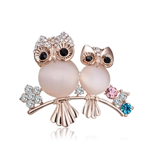 Elegant owl brooch with opal stones and crystals on a polished rose gold branch
