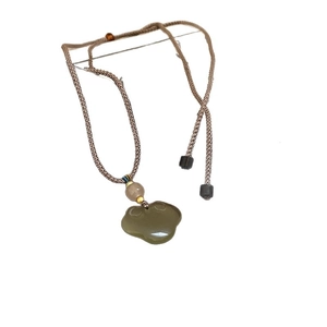 Handcrafted Chinese style necklace with a green jade cloud lock on a brown cord