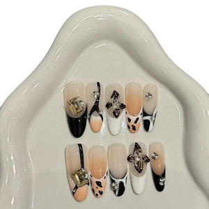 Handmade press-on nails with leopard print, 3D metal flowers, and rhinestone accents