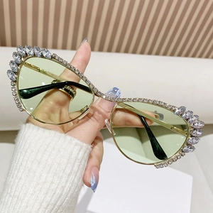 Luxury rhinestone cat-eye sunglasses with gold metal frame and pale green tinted lenses