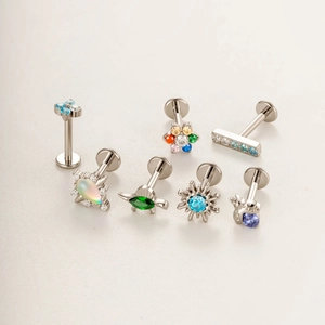 G23 titanium threadless studs featuring flower and geometric shapes with colored crystals