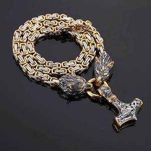 Detailed close-up of Mjolnir pendant with ornate wolf heads and Byzantine chain links