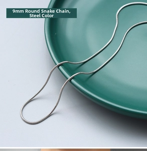 Detailed close-up of 1.3mm round snake chain in steel finish on a ceramic plate
