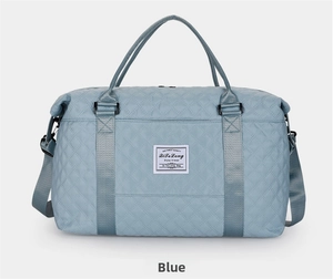 Close-up of light blue quilted fitness bag showing rhombic texture and zipper details