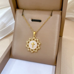 Detailed close-up of a gold star cross pendant necklace with sparkling diamonds